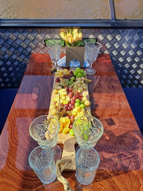 Amsterdam: Luxury Cheese & Wine Canal Cruise - Settling onto a traditional Dutch boat