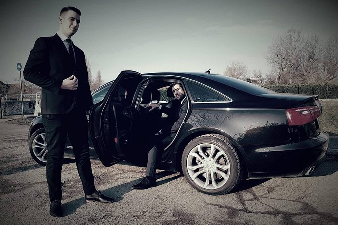 Budapest to Vienna Private Transfer in a Luxury Car - Airport arrivals with a name board