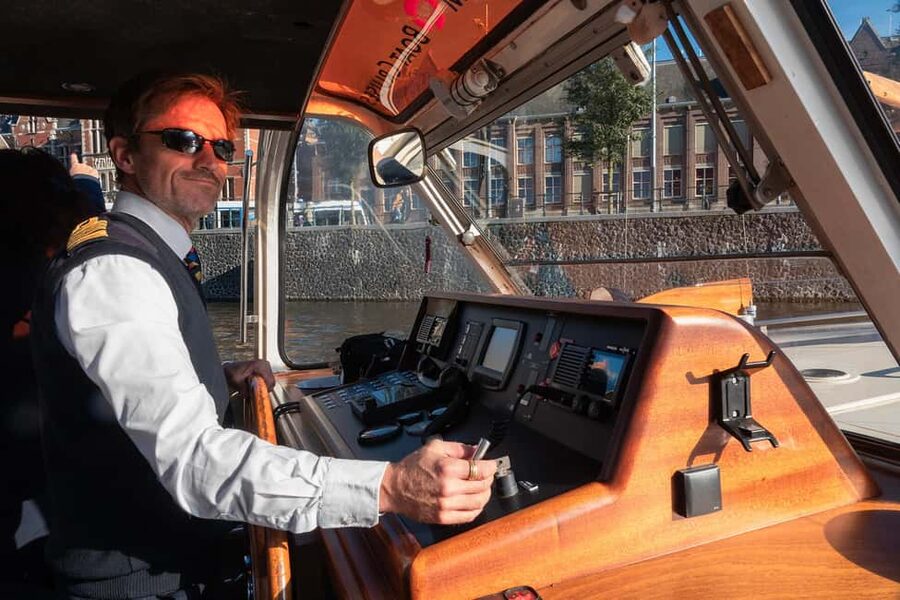 Discover Amsterdam: Luxury Canal Cruise with a Local Skipper - Live commentary, audio guides, and drinks