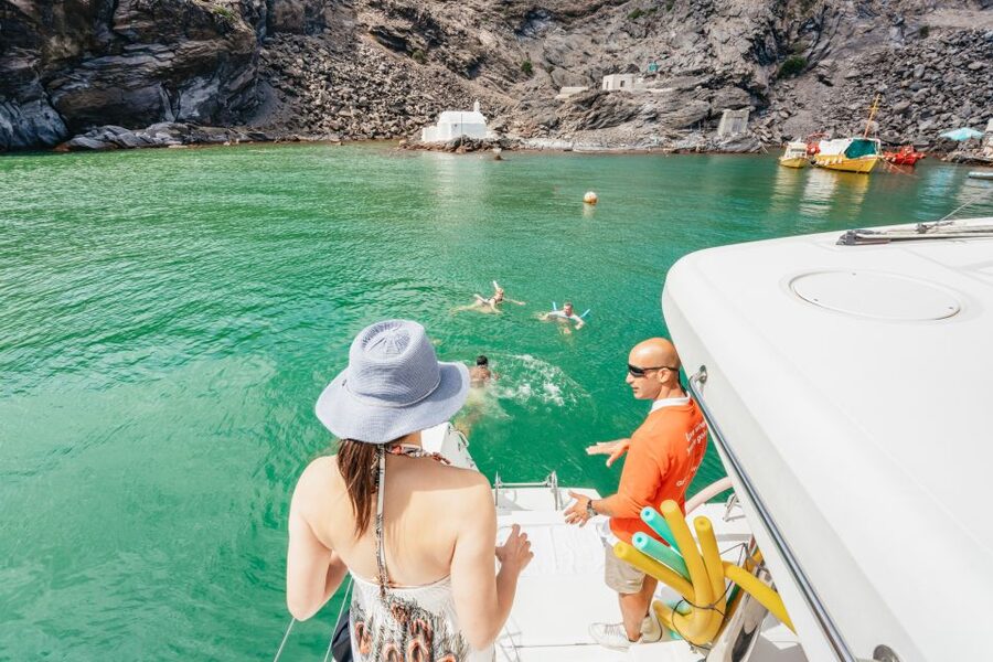 Santorini: Luxury Catamaran Day Trip with Meal and Open Bar - Open bar, music, and the mood on deck