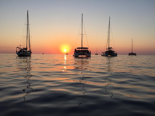 Santorini Luxury Catamaran Sunset Cruise with BBQ, Drink and Transfer - White Beach, Barbecue, and Longest Stop