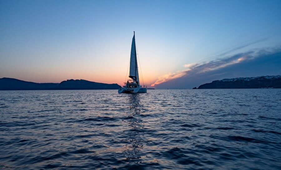 Santorini: Luxury Sunset Cruise with Dinner & Open Bar - Sailing past Thirassia and the caldera cliffs